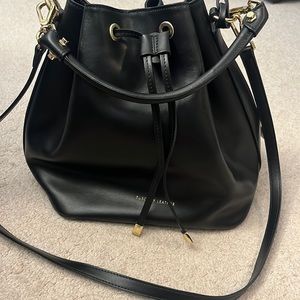 Crossbody bucket bag with dust bag